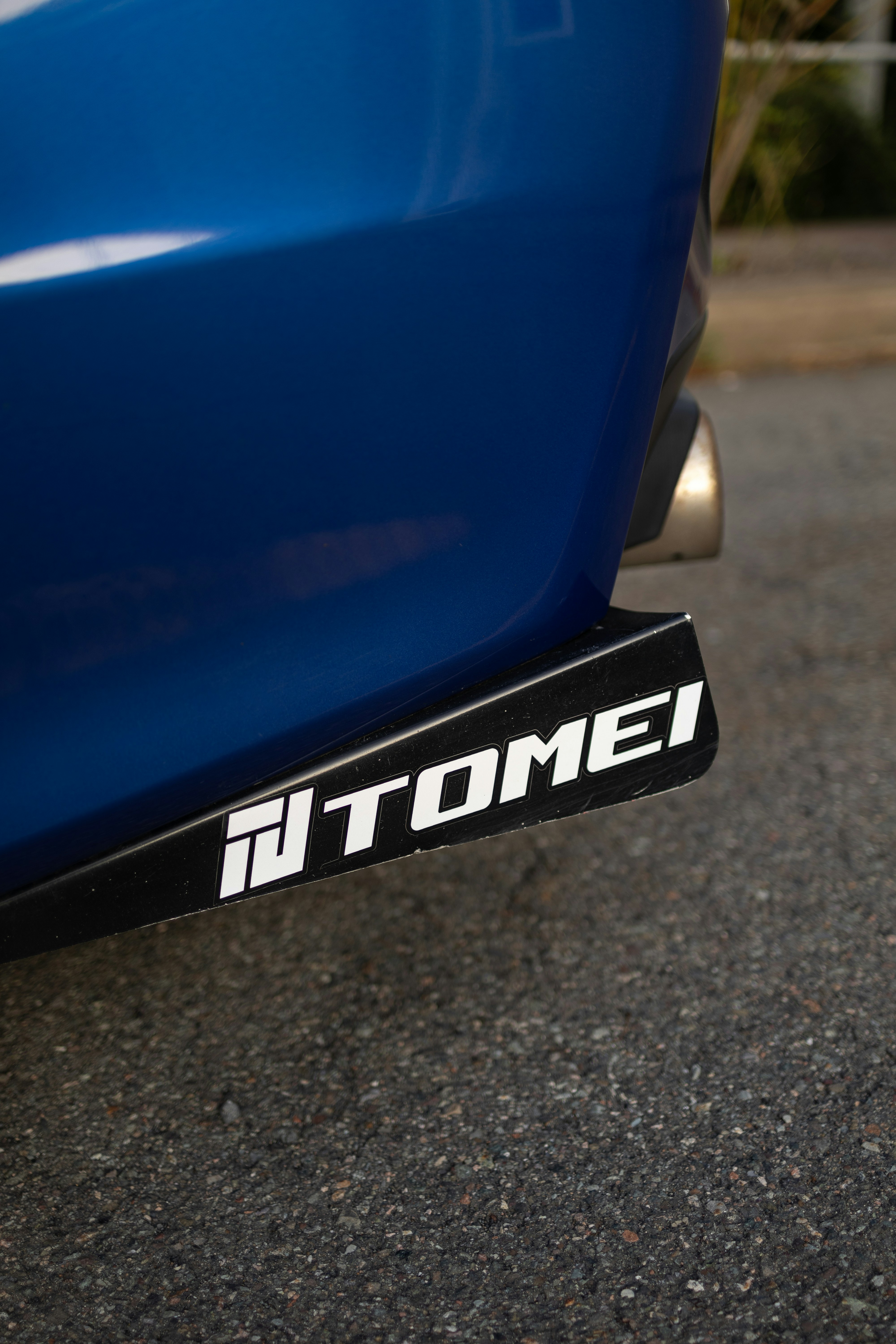 A close up of a blue car parked on the street