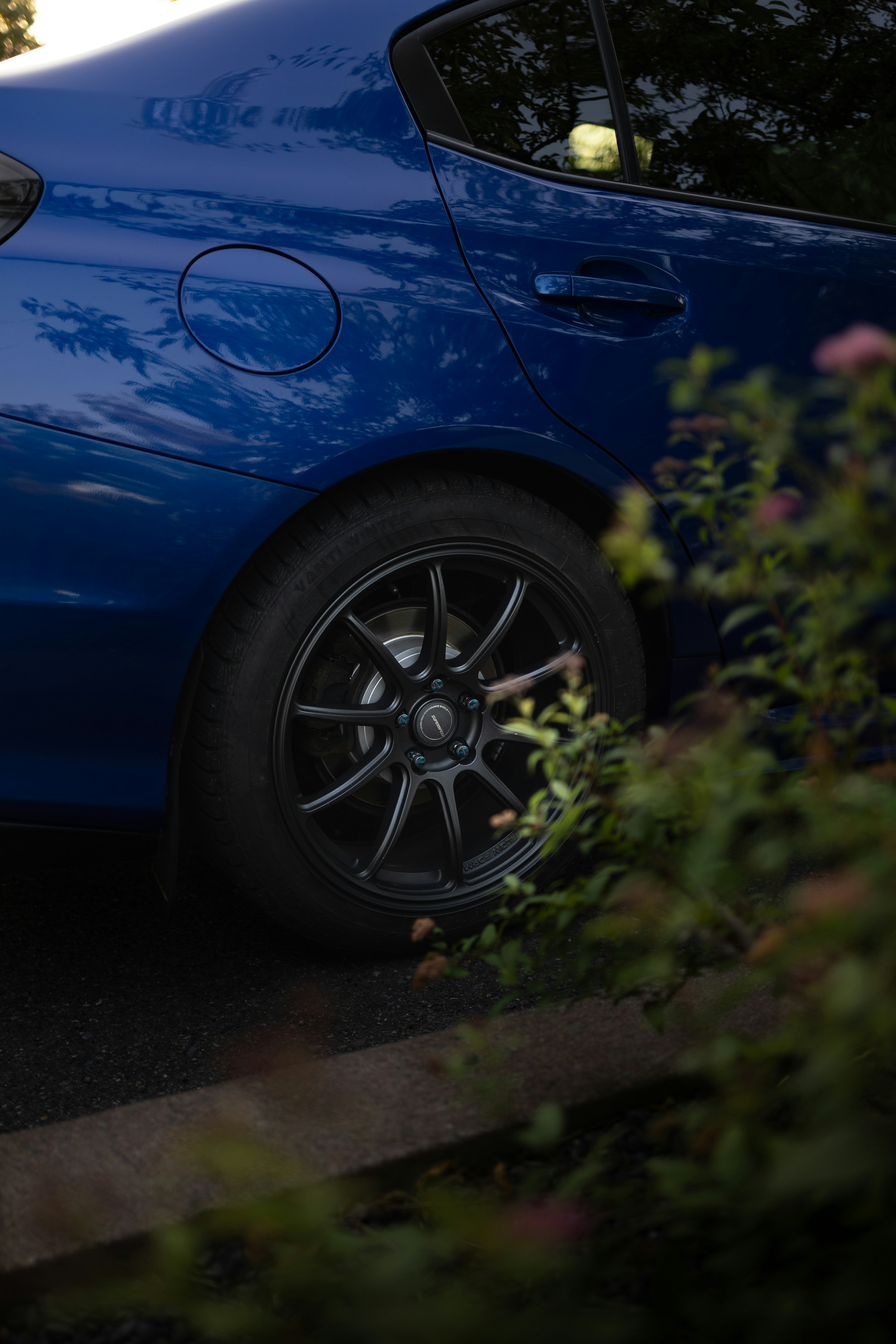 A blue car parked on the side of the road