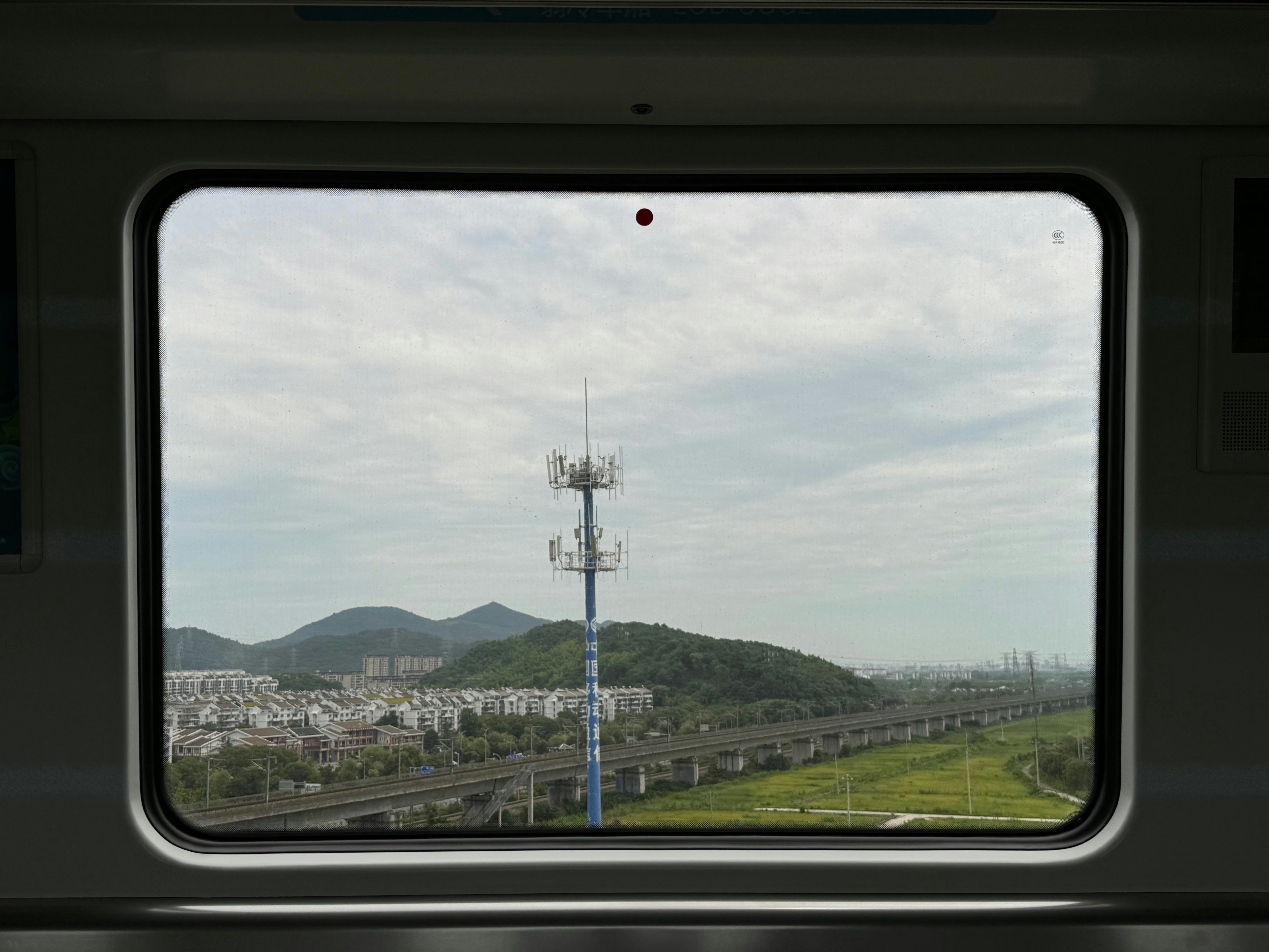 A view from inside a train looking out the window