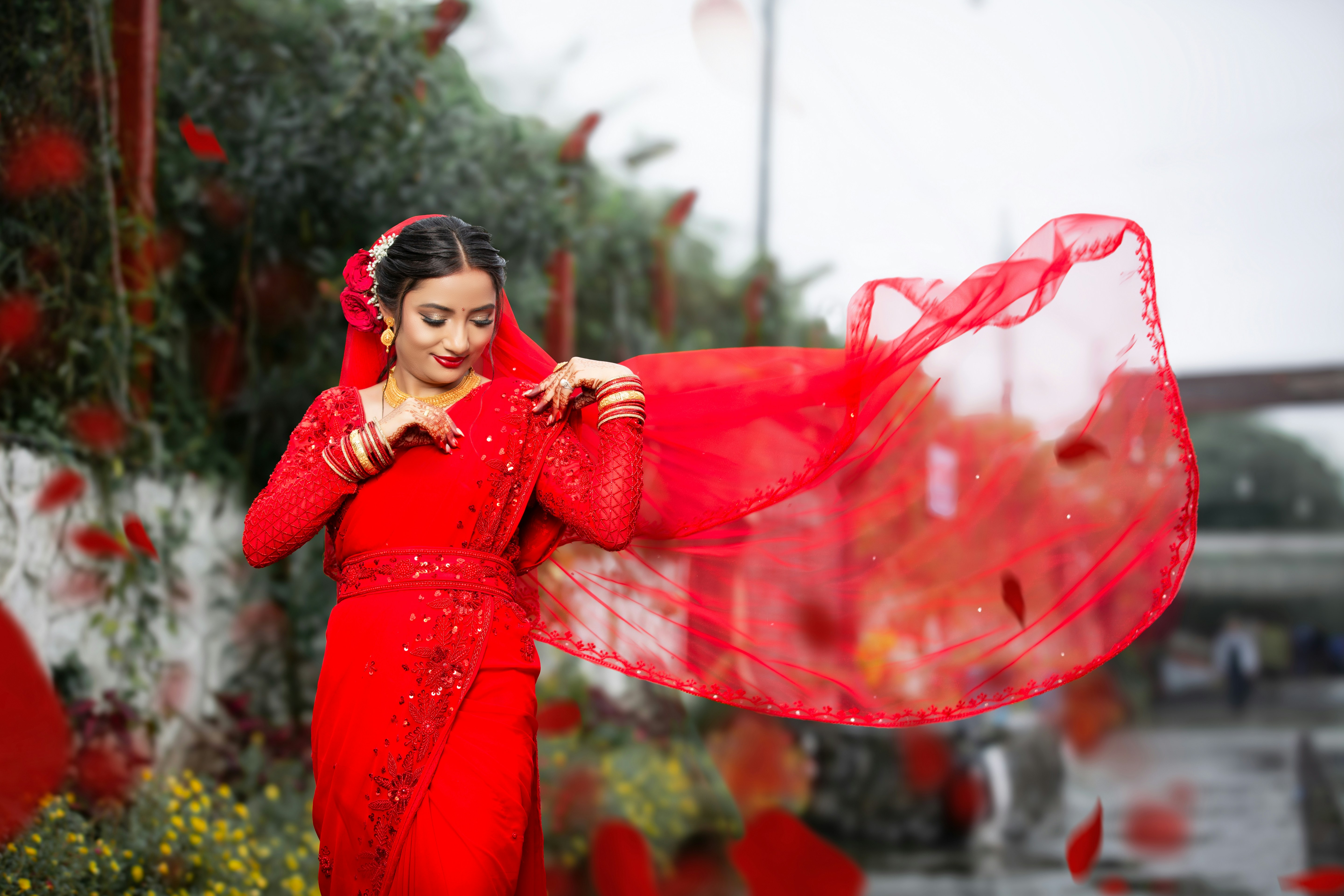 A woman in a red dress holding a red scarf