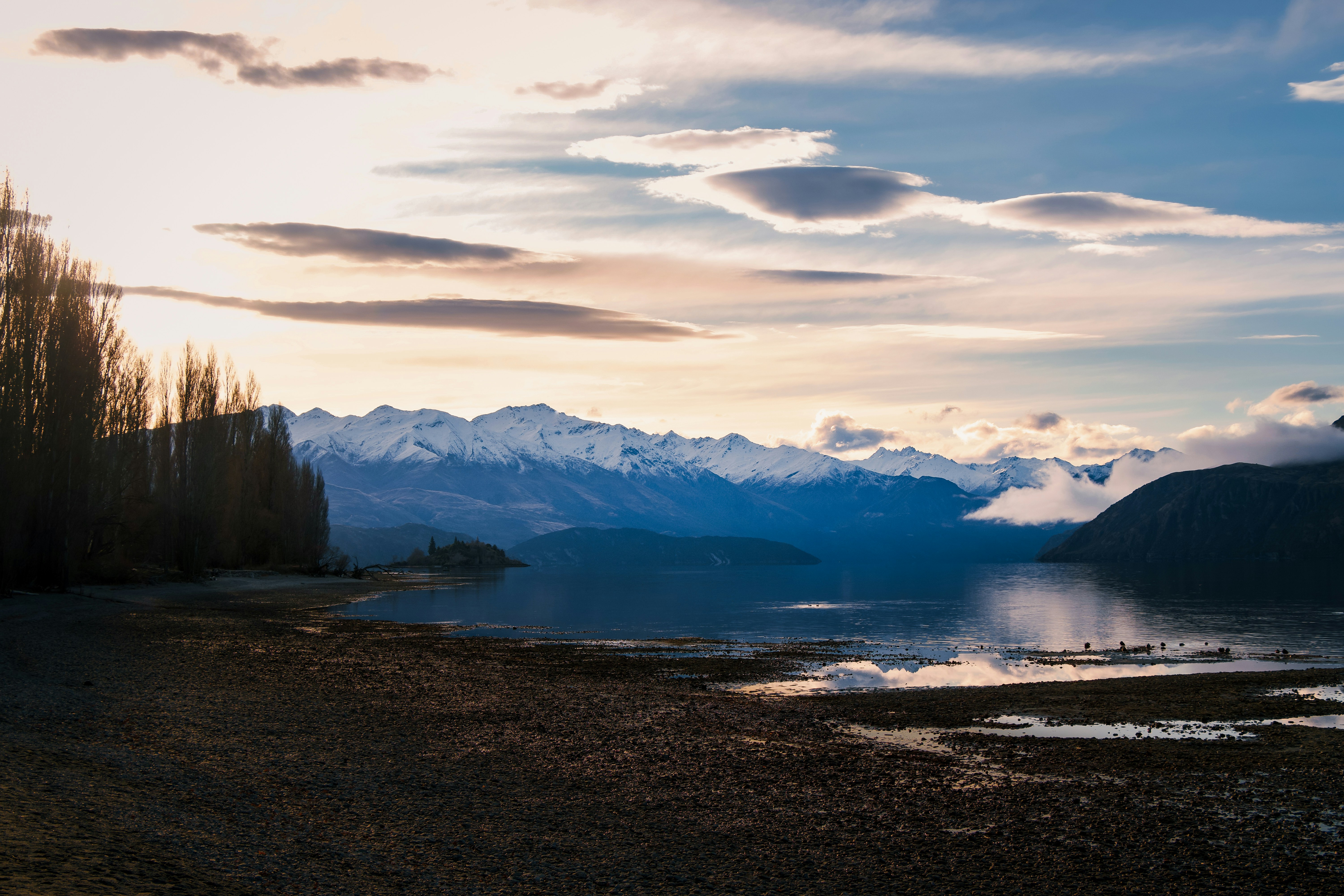 A body of water with mountains in the background