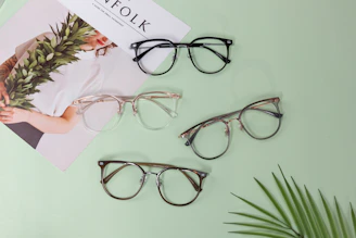 Three pairs of glasses sitting on top of a table
