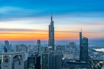 A view of a city at sunset from the top of a building
