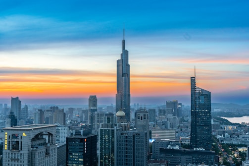 A view of a city at sunset from the top of a building
