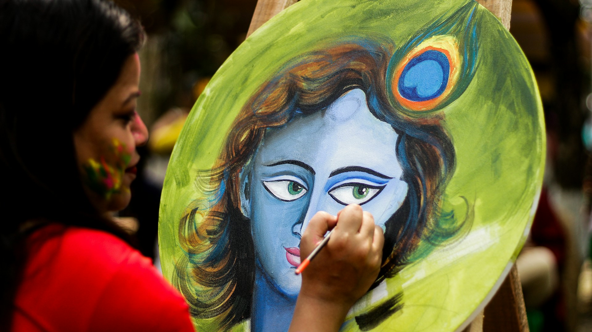 A woman painting a picture of a woman's face