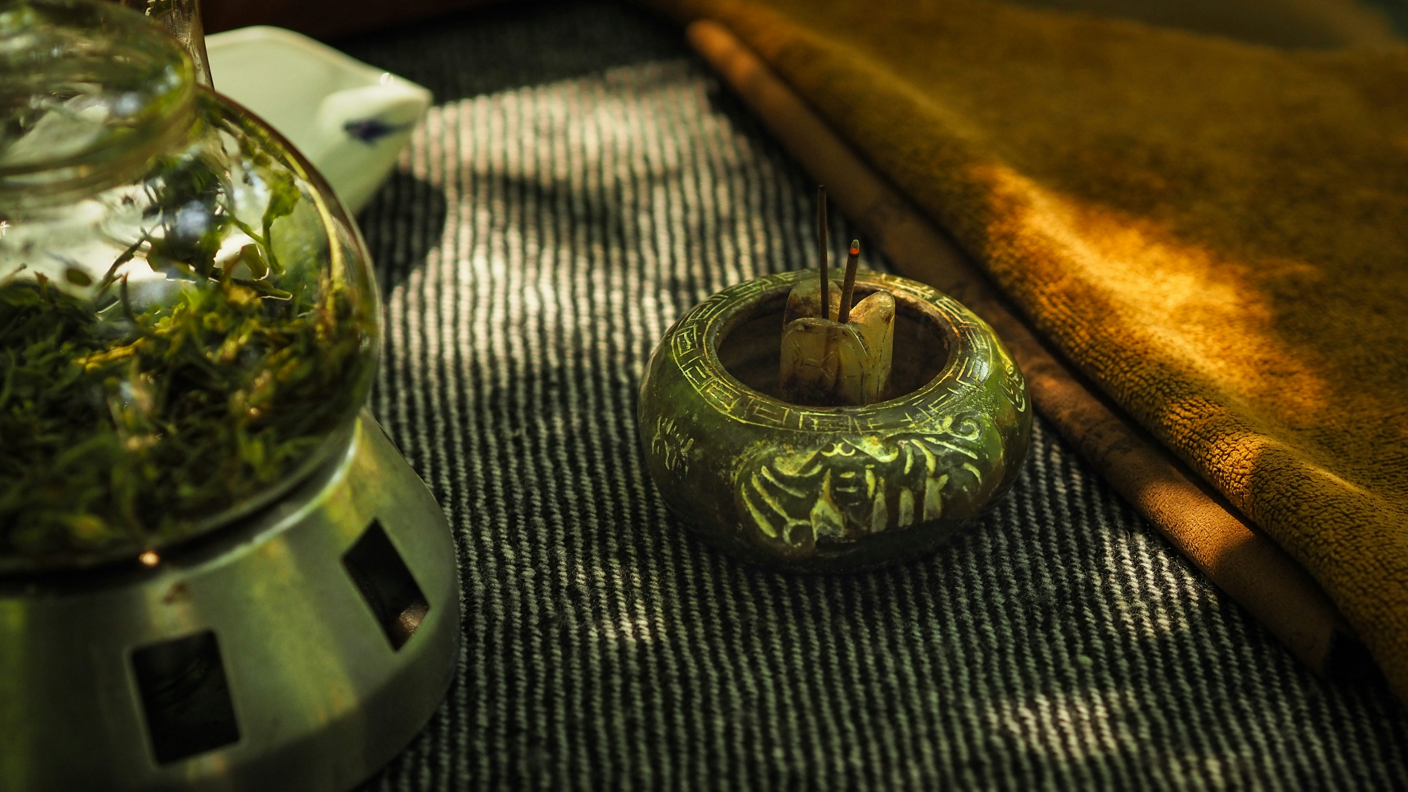 A close up of a vase with plants inside of it