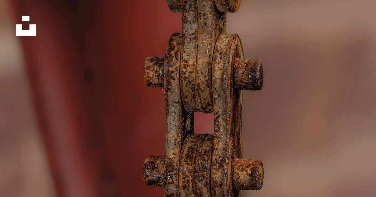 A rusted metal object hanging from a brick wall photo – Free Rust Image ...