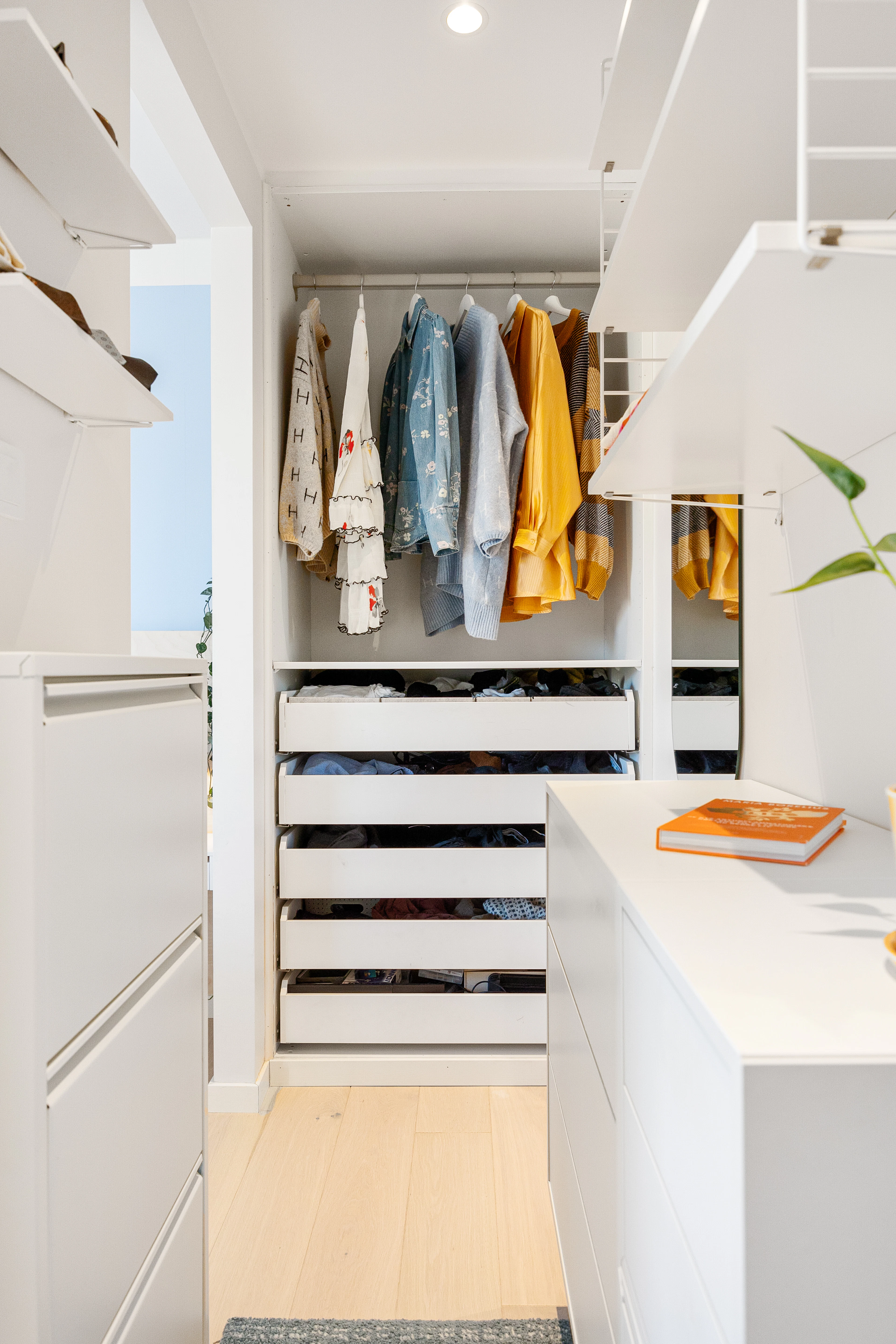 White closet with drawers and a center island