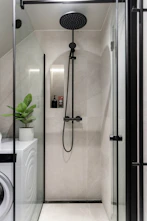 A washer and dryer in a small bathroom