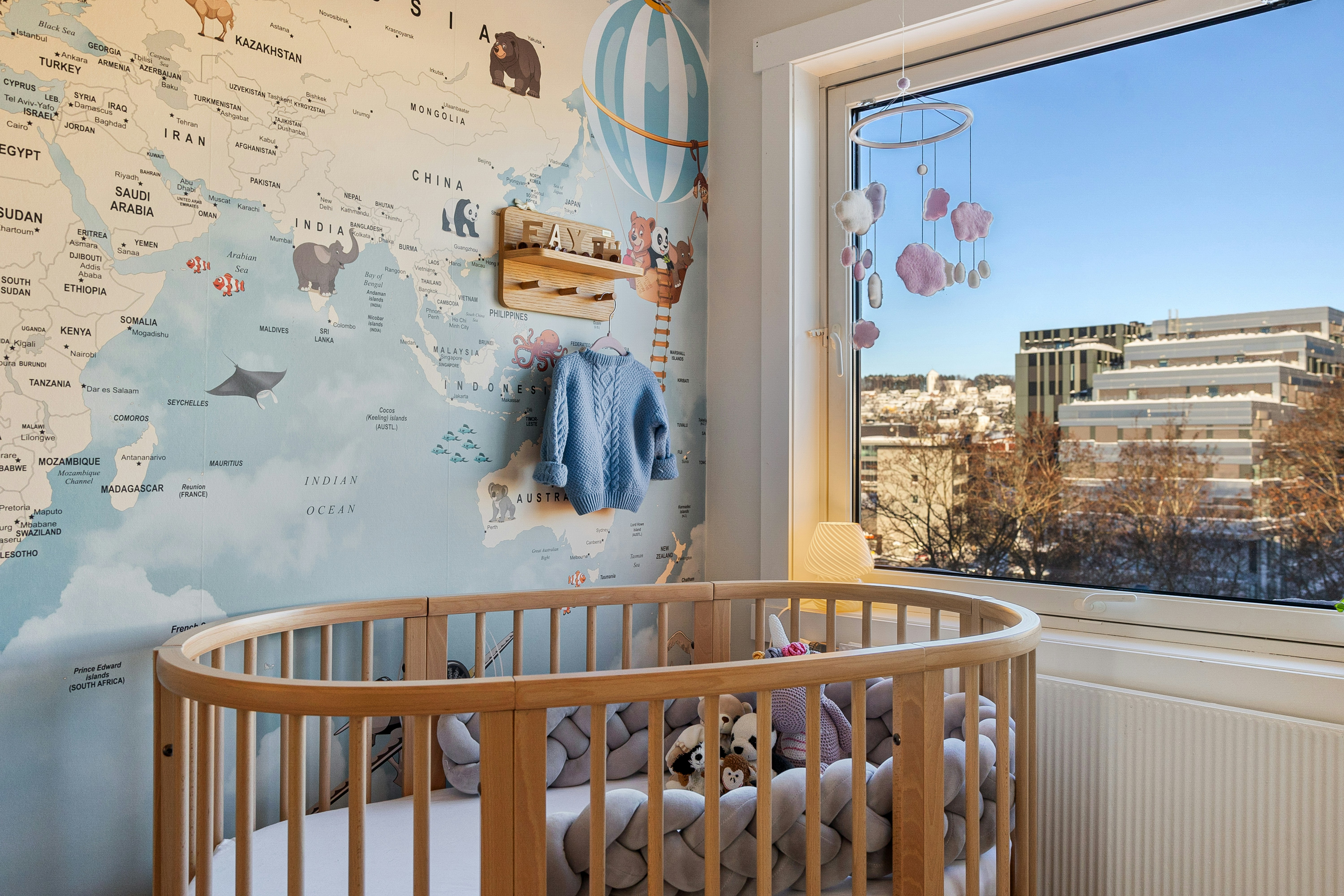 A baby's room with a map of the world on the wall