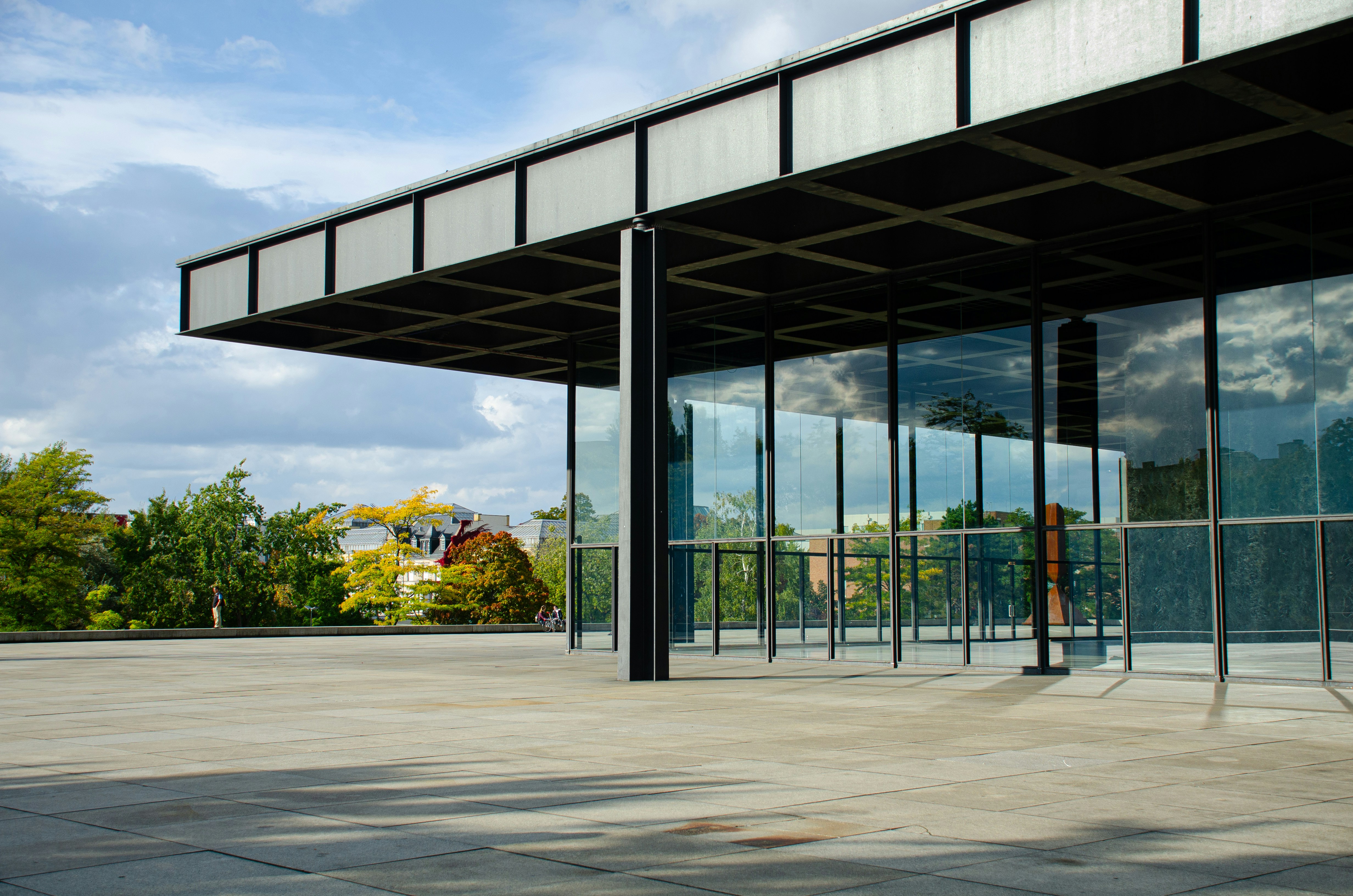 An empty parking lot with a large building in the background, 