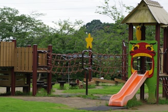 A children's play area with a slide and climbing frame