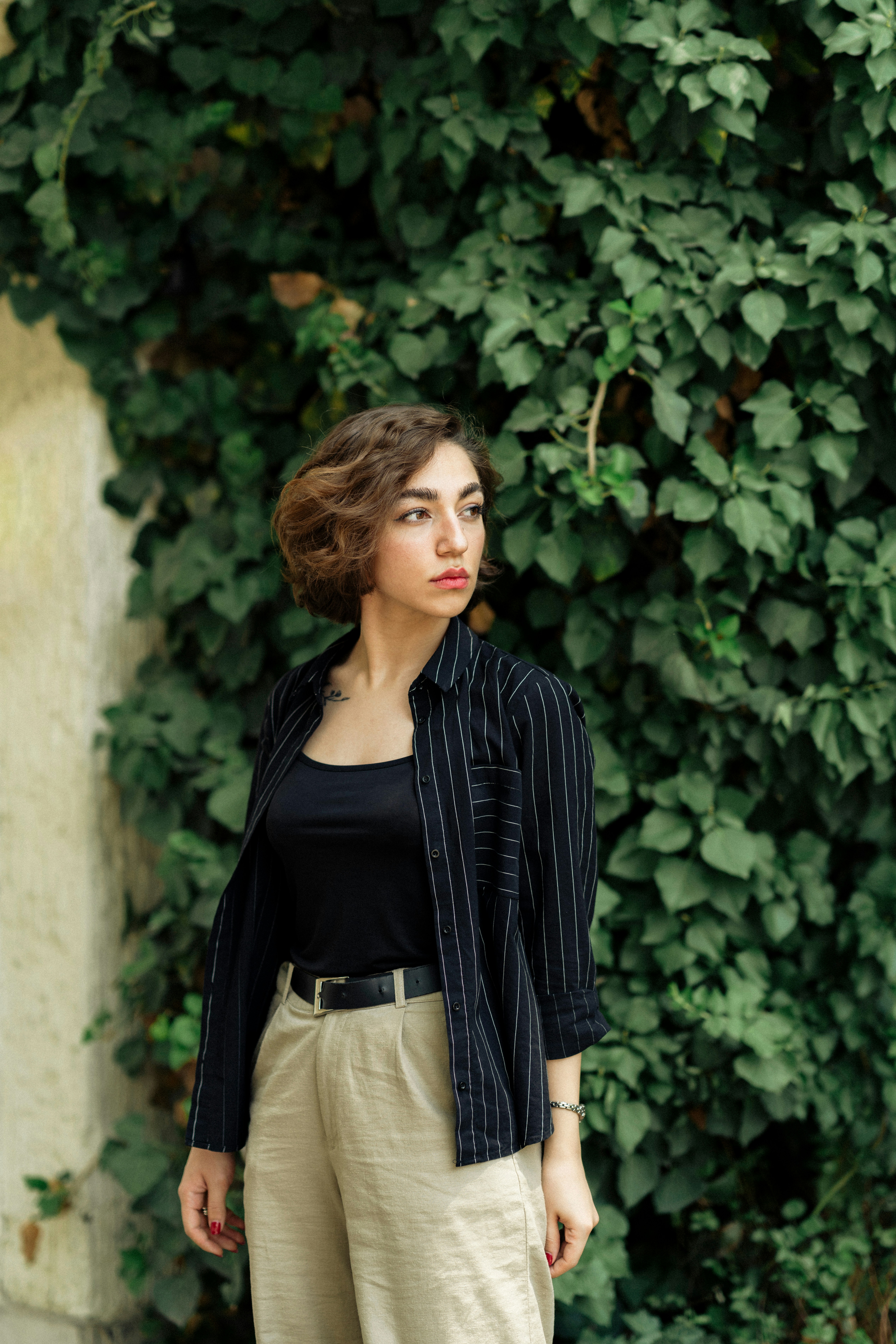 A woman standing in front of a green wall