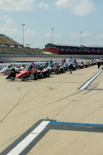 A row of RACE cars lined up on a race track