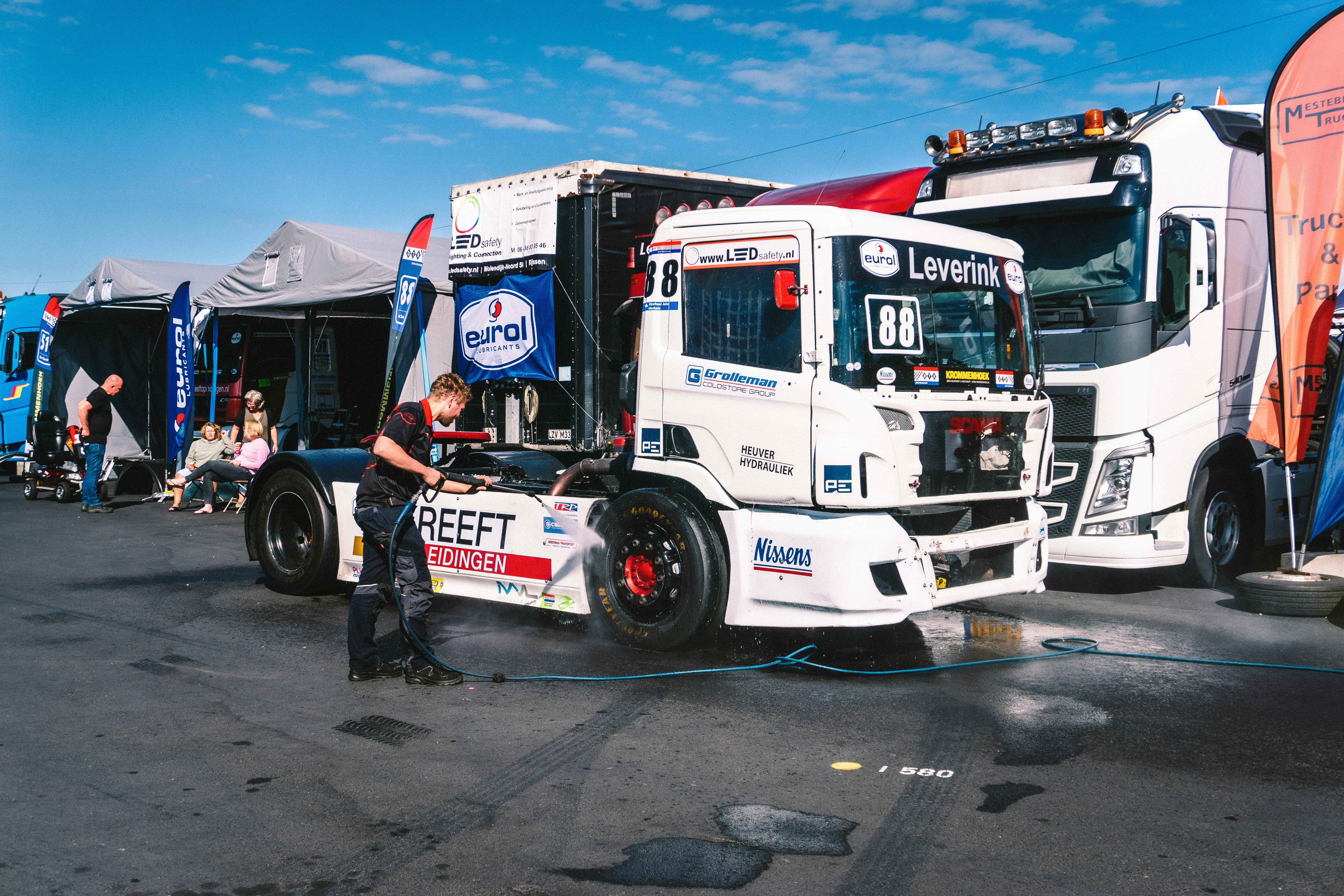 A group of semi trucks parked next to each other