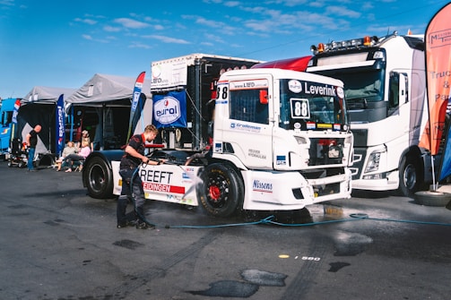 A group of semi trucks parked next to each other