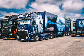 A group of semi trucks parked next to each other