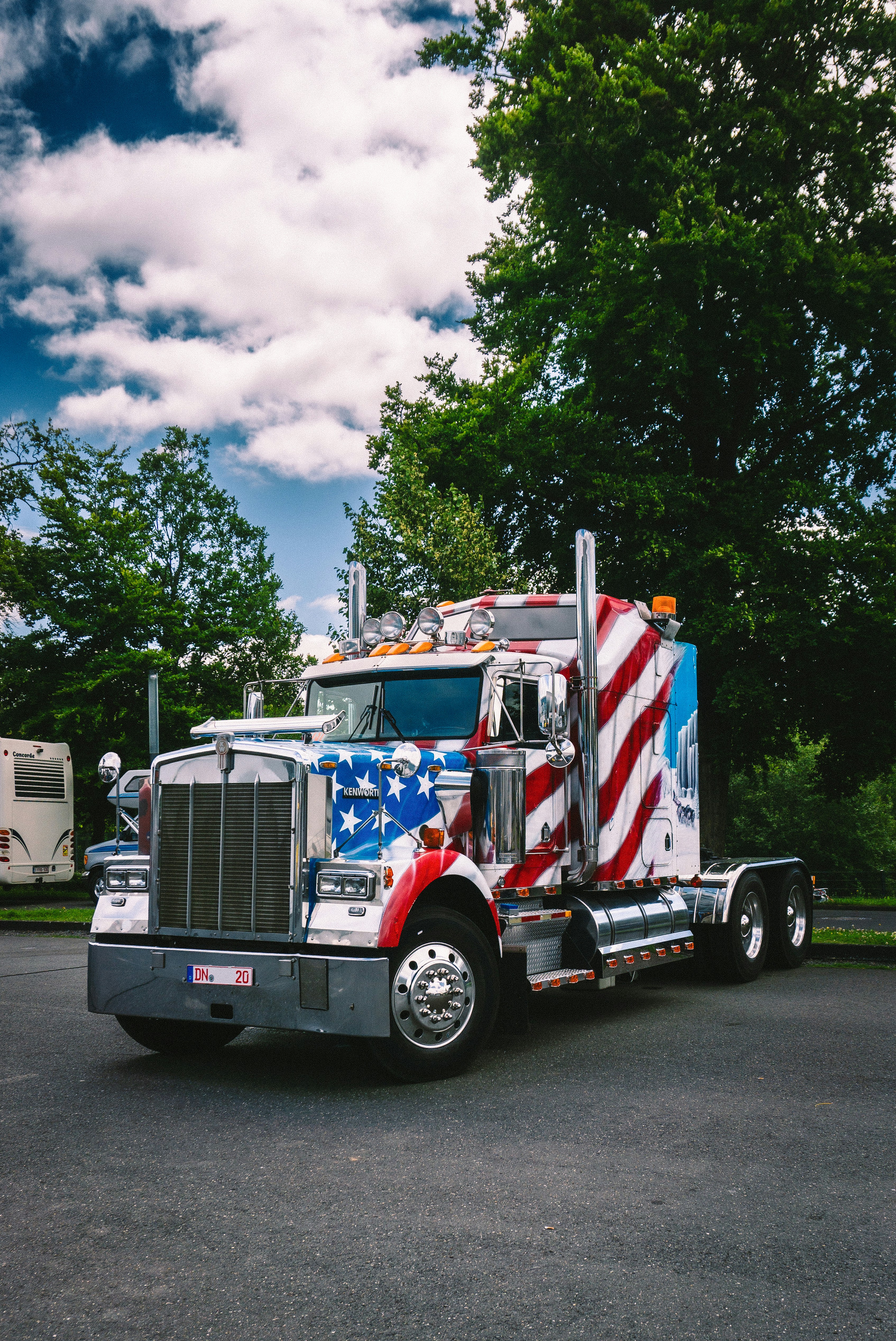 A semi truck with an american flag painted on the side