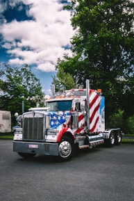 A semi truck with an american flag painted on the side