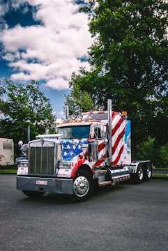A semi truck with an american flag painted on the side