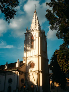 A large white church with a steeple on a sunny day
