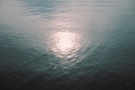 A large body of water sitting under a cloudy sky