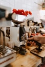 A person using a grinder on a wooden table