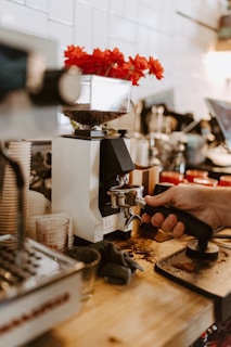 A person using a grinder on a wooden table
