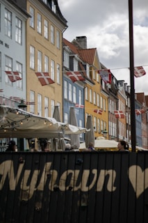 A row of buildings with flags flying in the wind