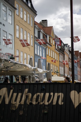 A row of buildings with flags flying in the wind
