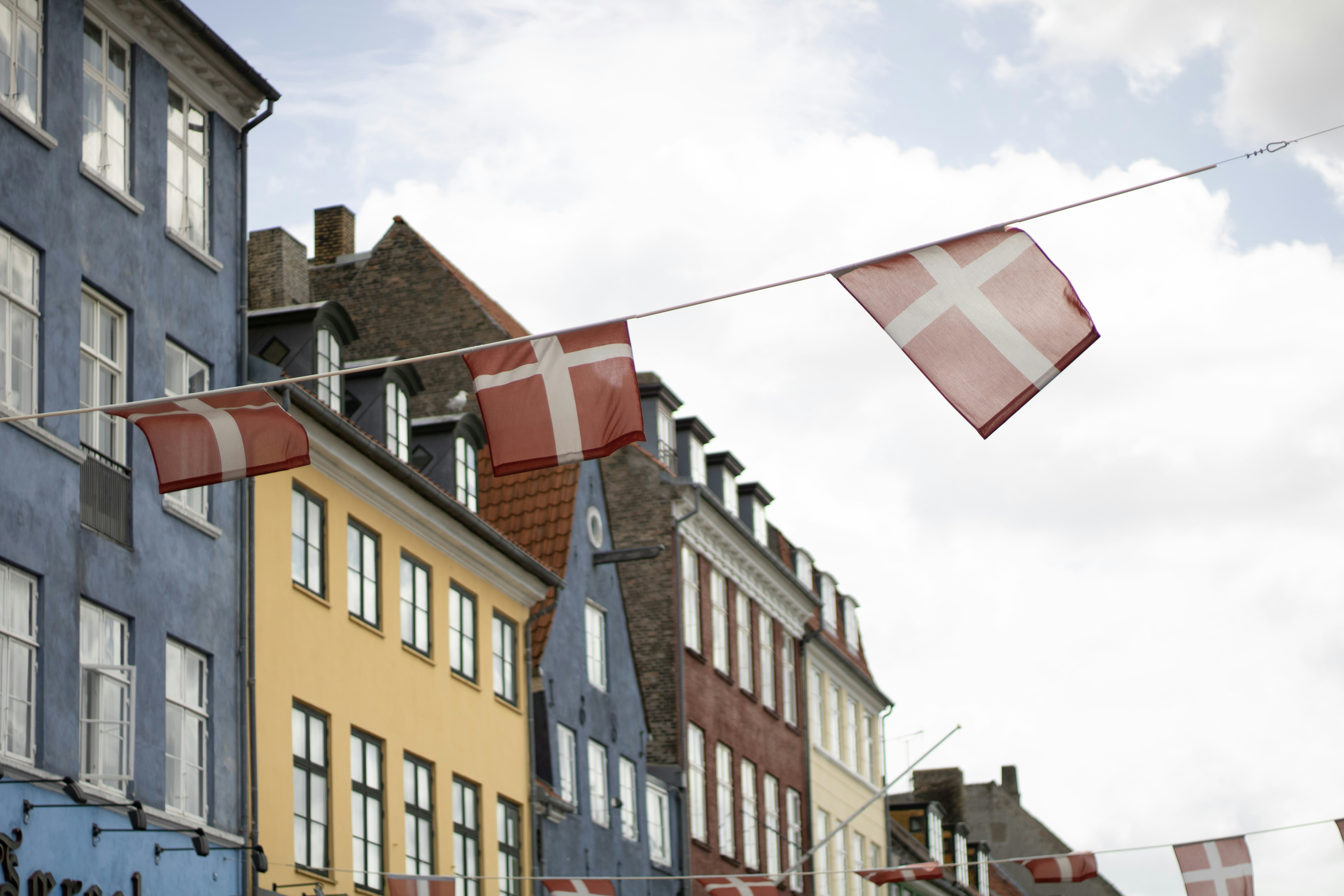 A row of buildings with a flag flying in the wind