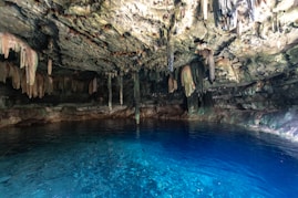 A cave filled with blue water and lots of caves