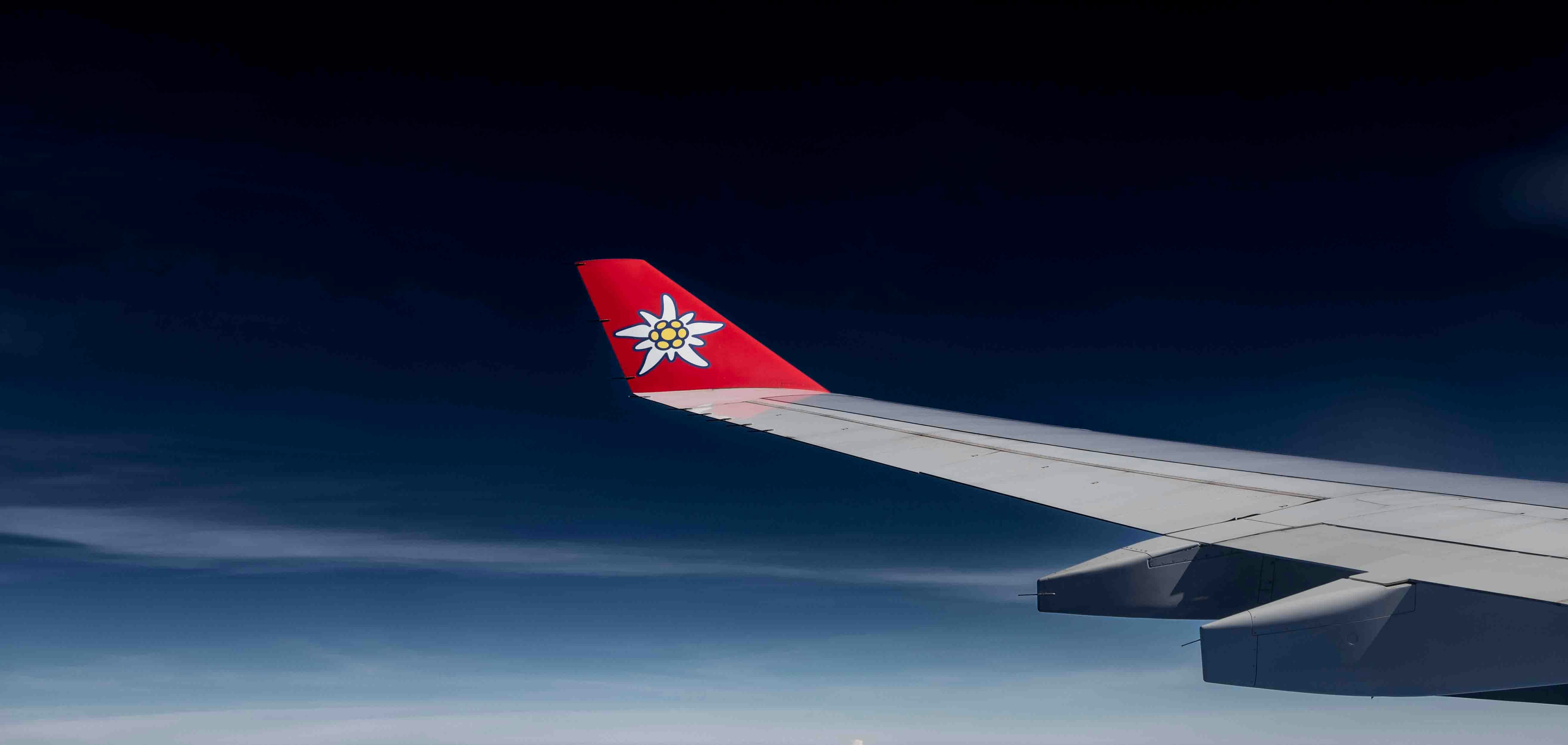airplane in flight aerial view - A view of the wing of an airplane in the sky