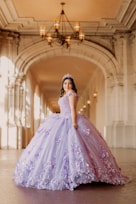 A woman in a purple dress standing in a hallway
