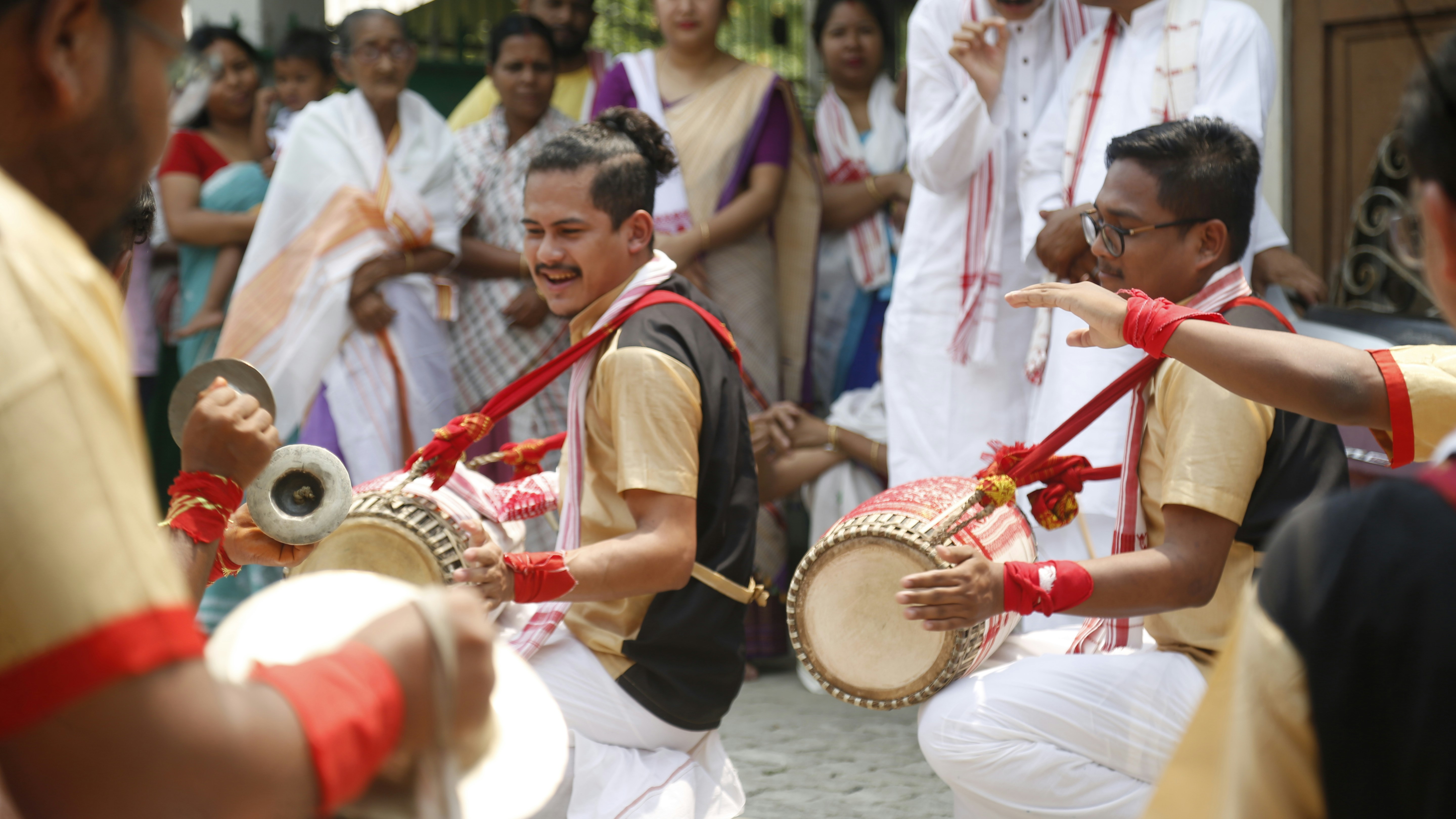 A group of people playing musical instruments in front of a crowd