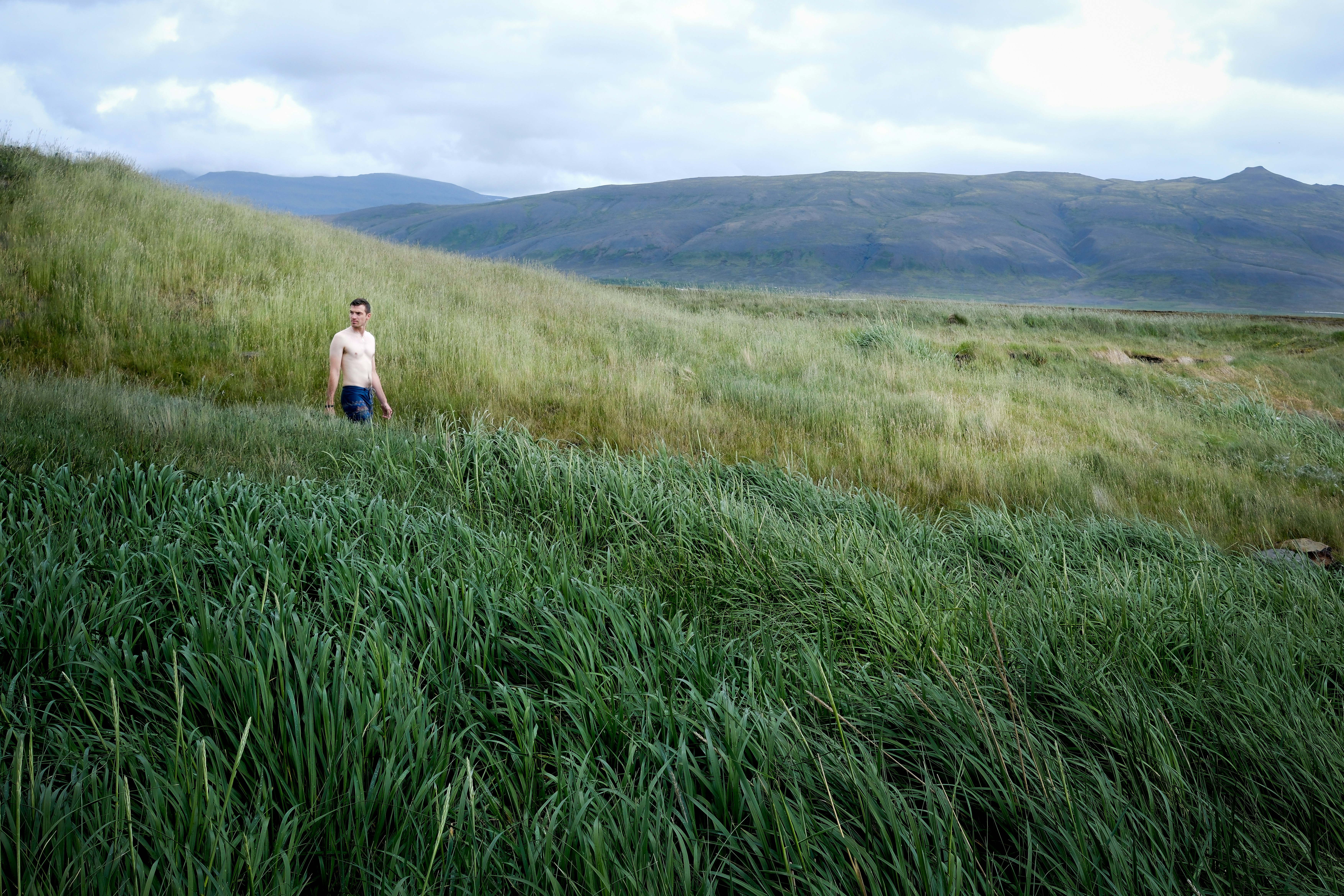 A man standing in a field of tall grass