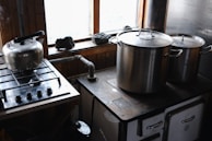 A stove top oven sitting next to a window
