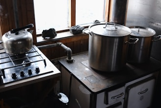 A stove top oven sitting next to a window