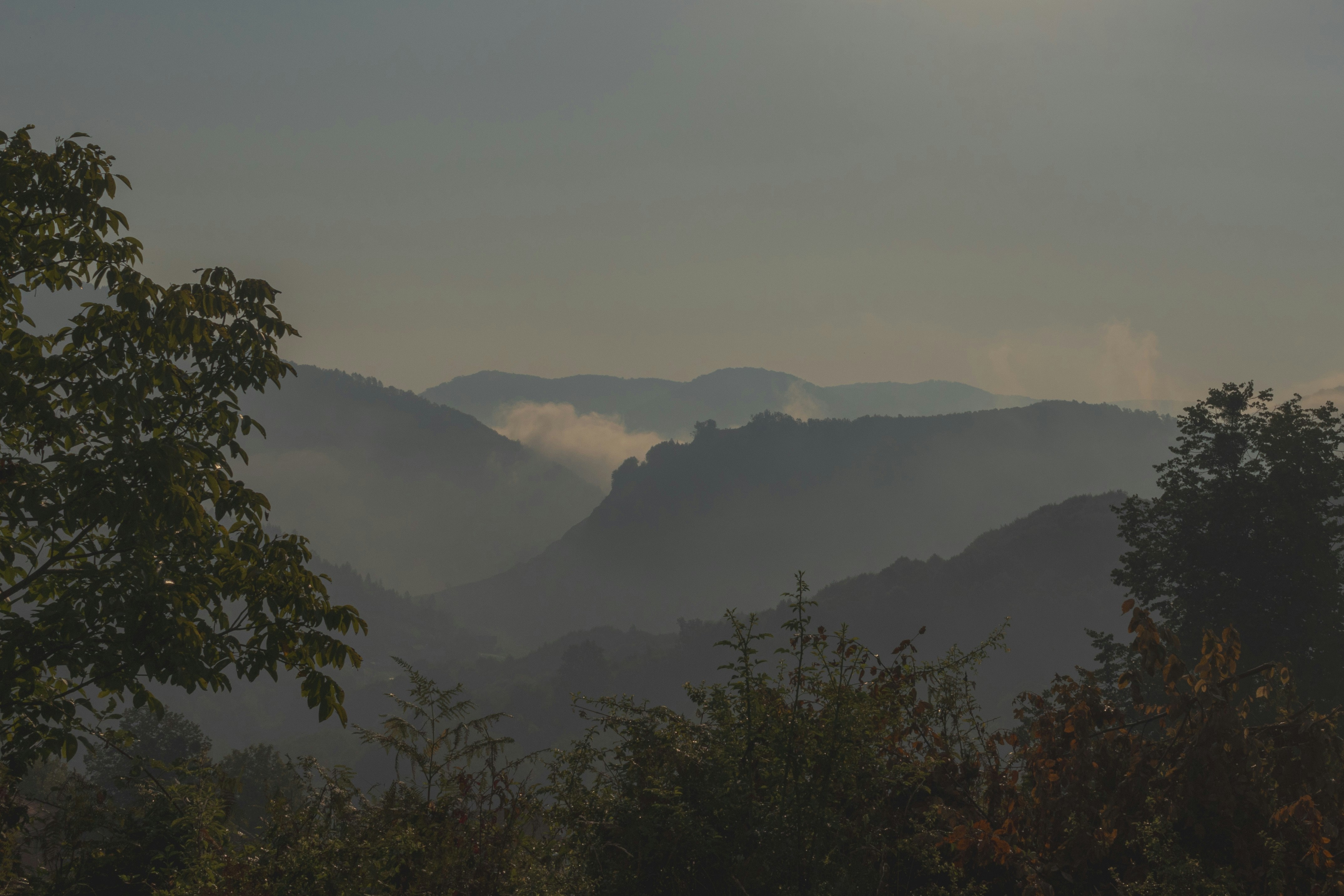 El sol brilla sobre las montañas a lo lejos