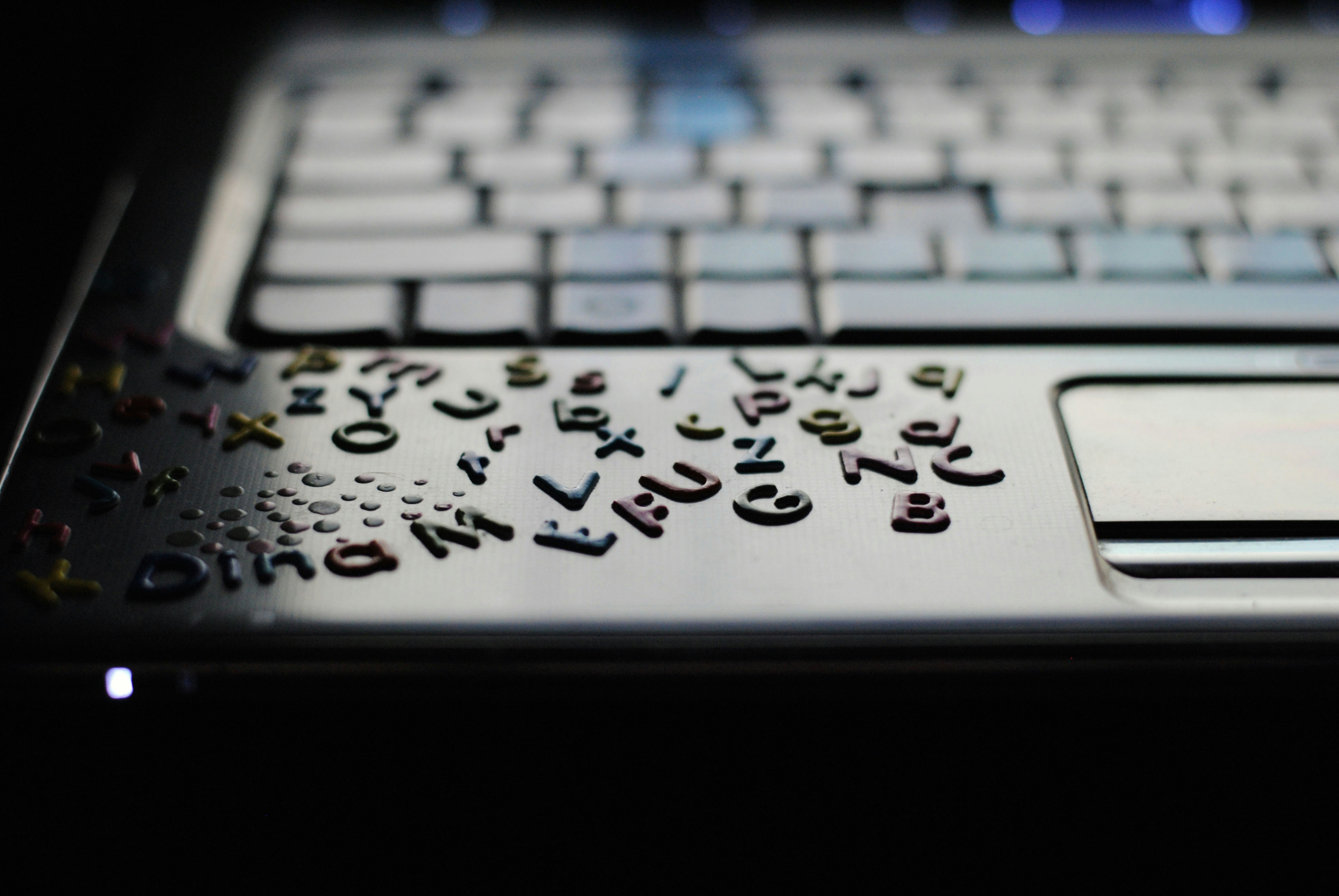 A close up of a computer keyboard in the dark