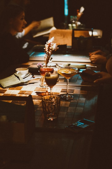 A group of people sitting around a wooden table