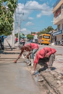 A couple of people that are standing on a sidewalk