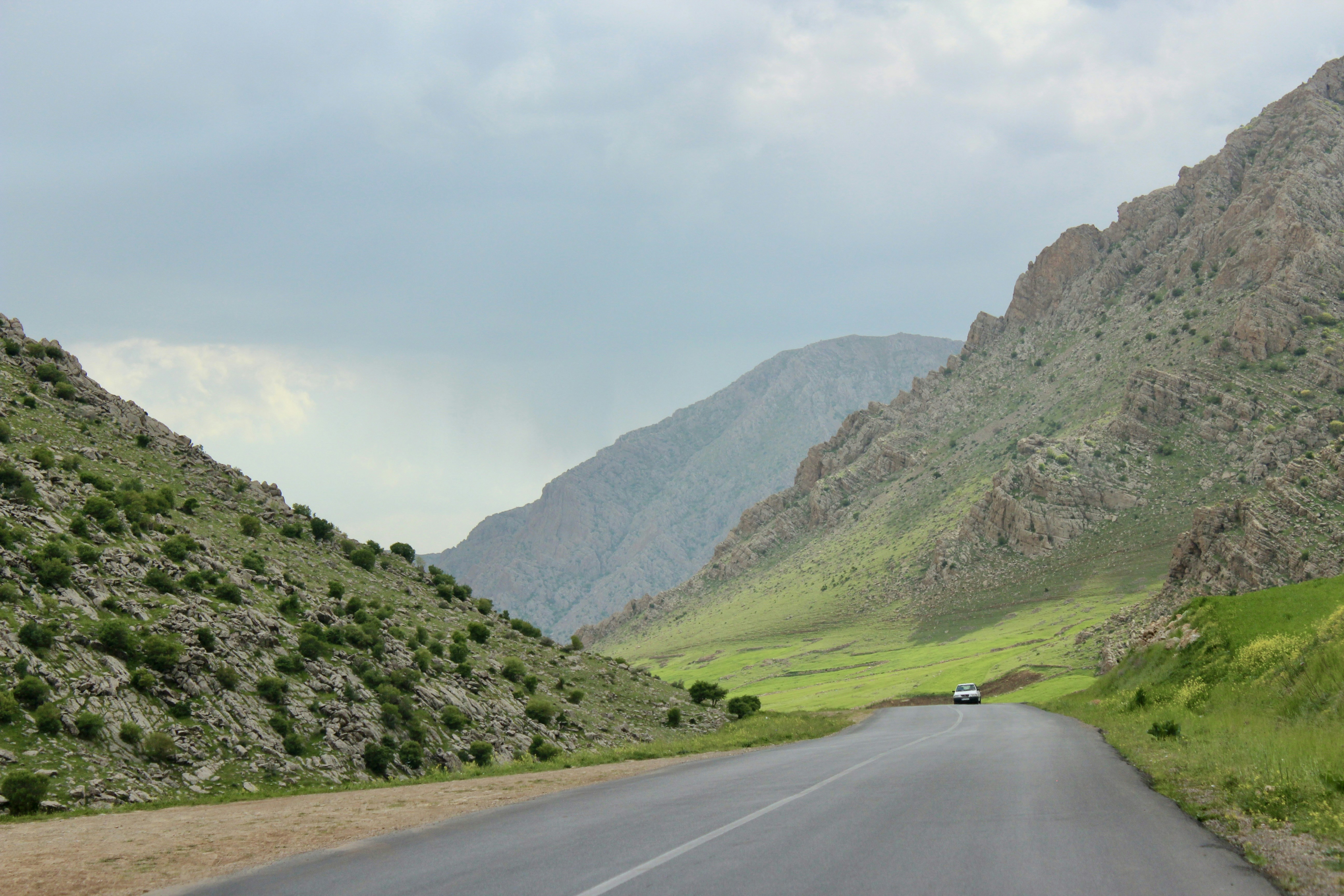A car driving down a road in the mountains