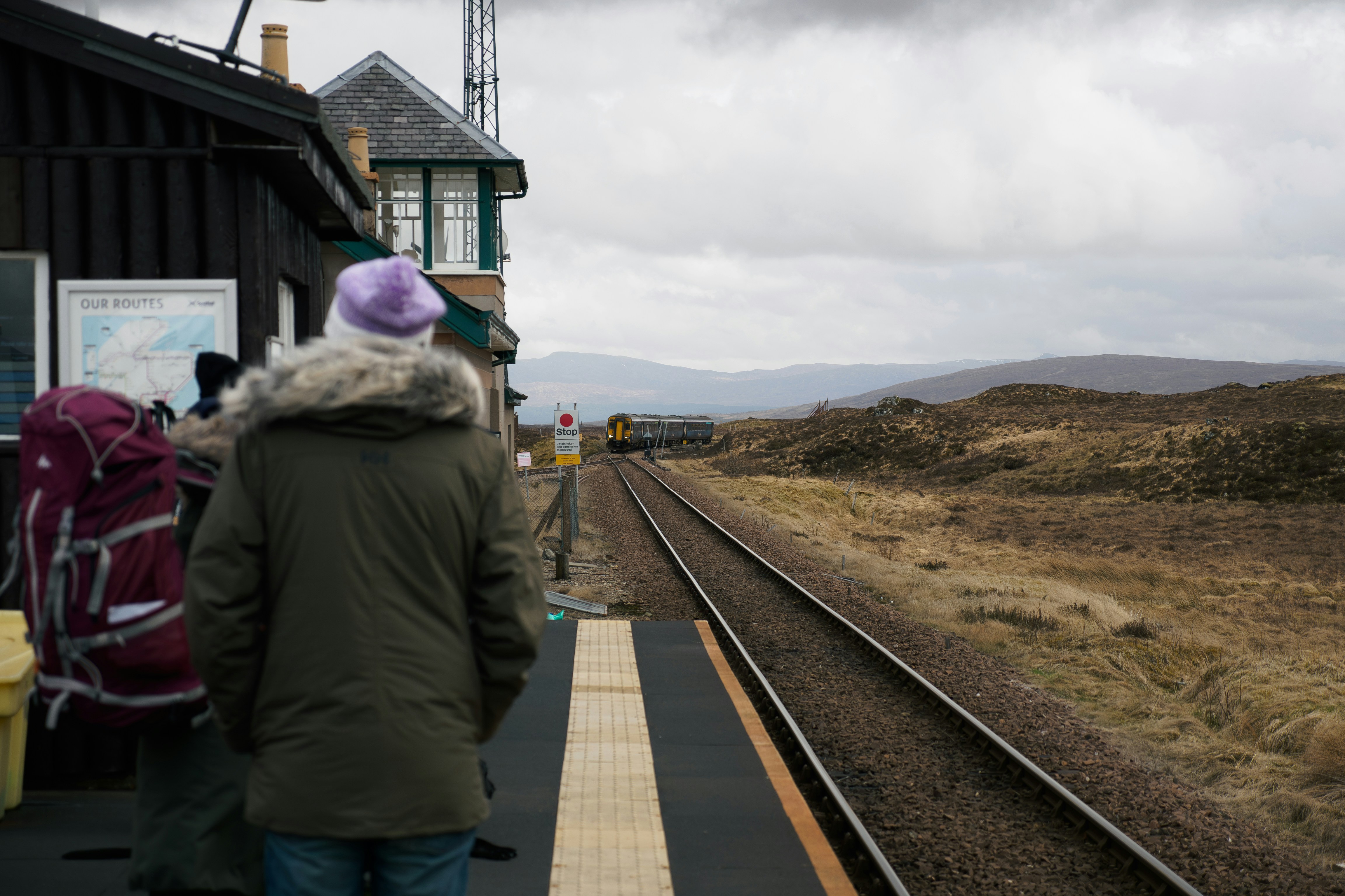 A group of people waiting at a train station