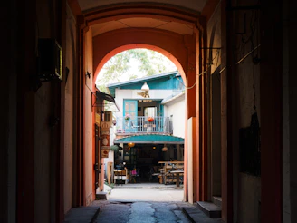 An open doorway leading to a building with a green awning
