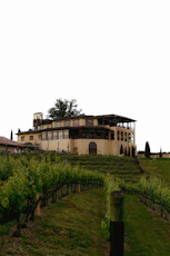 A large house sitting on top of a lush green hillside