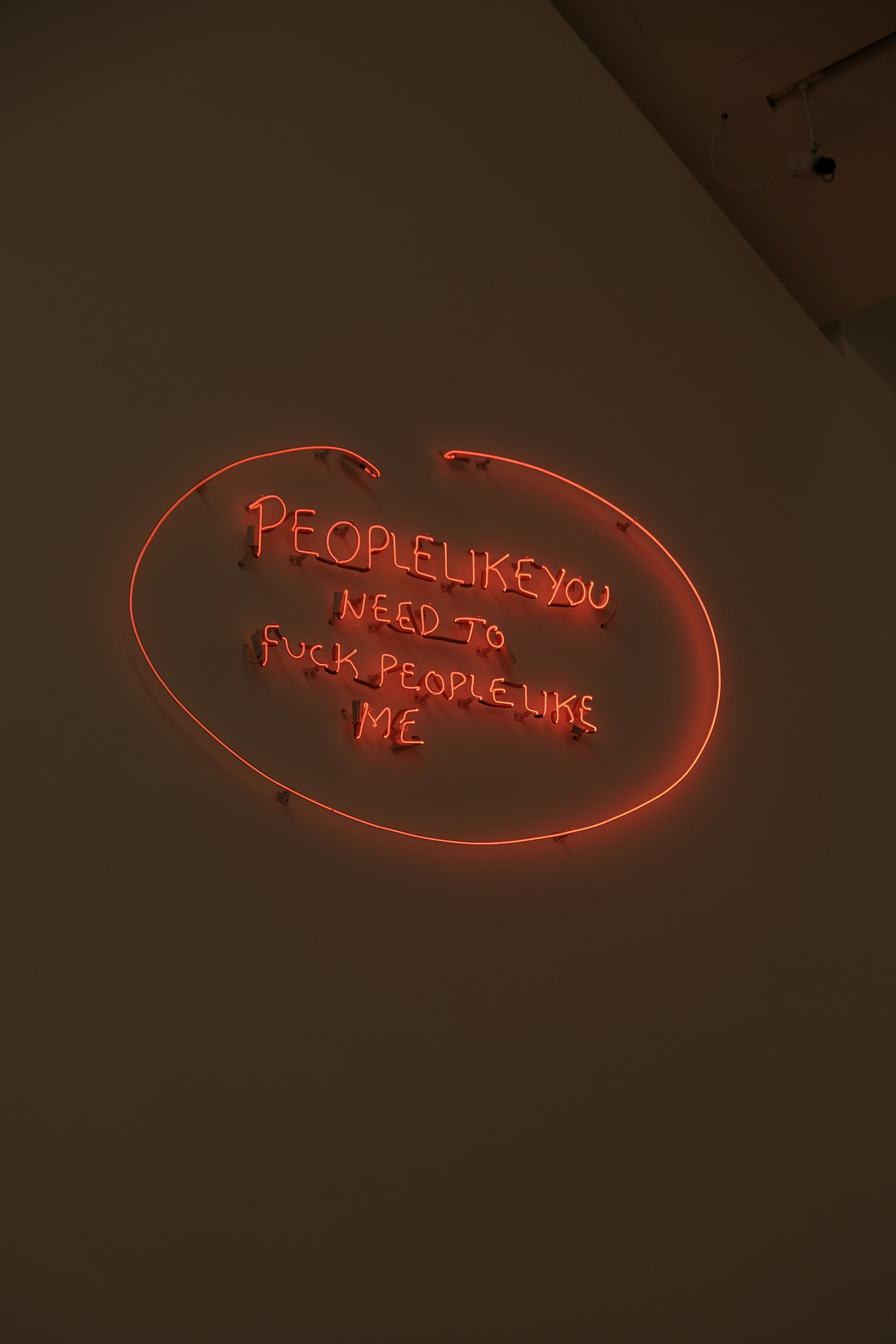 A neon sign that says people like you need to fucking people like me