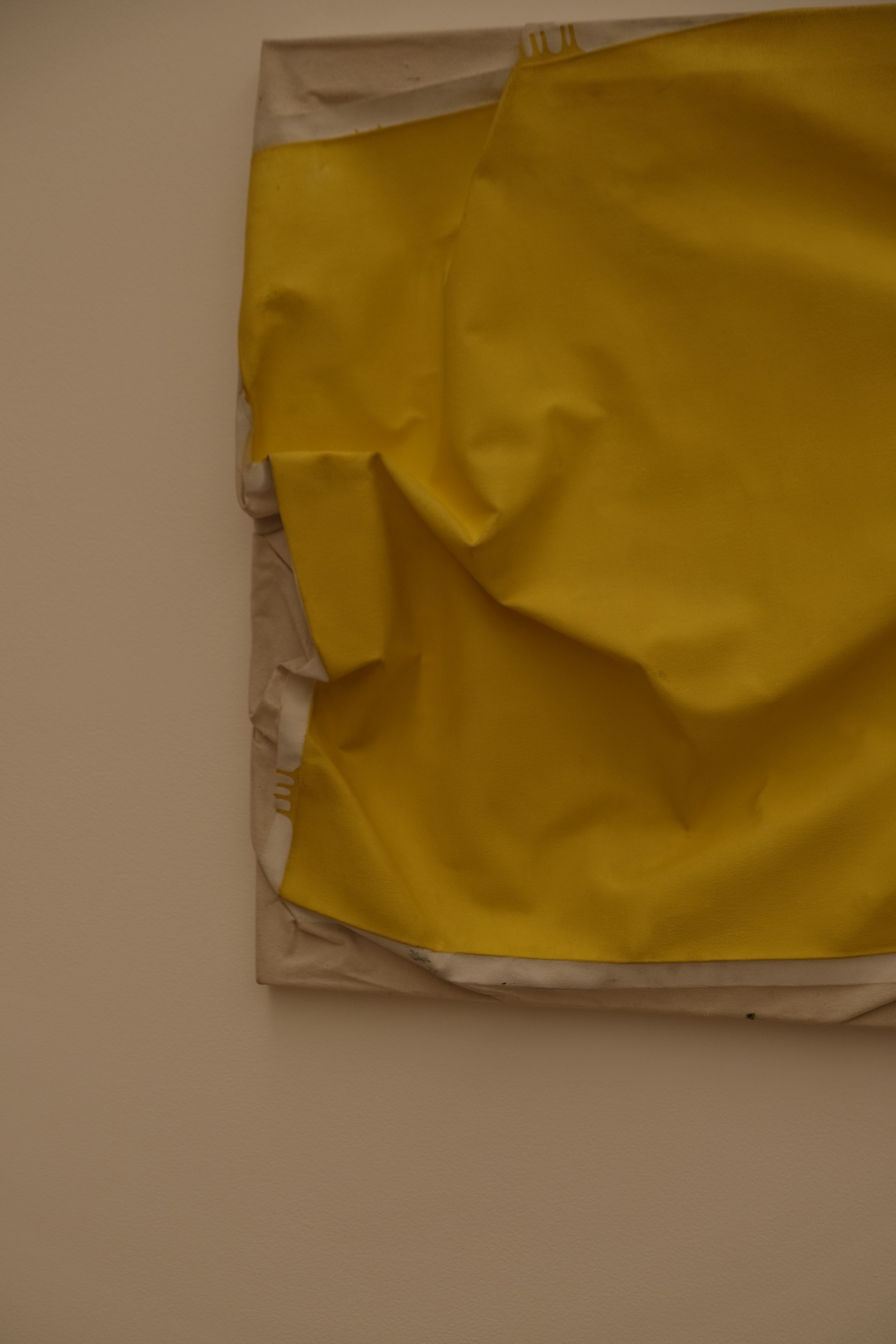 A piece of yellow paper on a wall