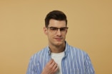 A man wearing glasses and a blue striped shirt