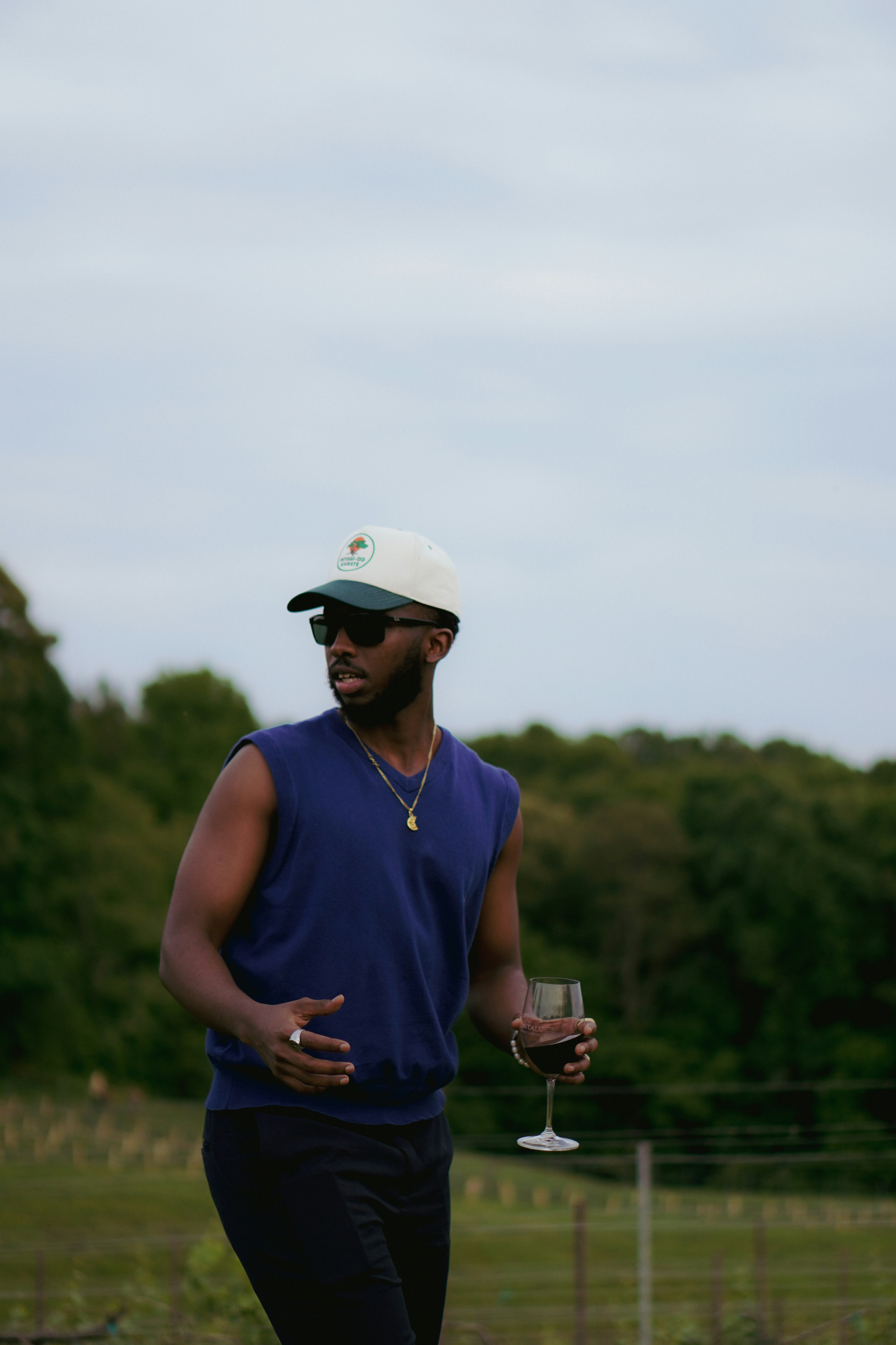 A man holding a wine glass and a wine glass